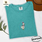 Seafoam Comfort Colors T-shirt embroidered with a cream goose in a Santa hat with a red ribbon bow at its neck