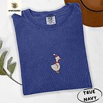 True Navy Comfort Colors T-shirt embroidered with a cream goose in a Santa hat with a red ribbon bow at its neck