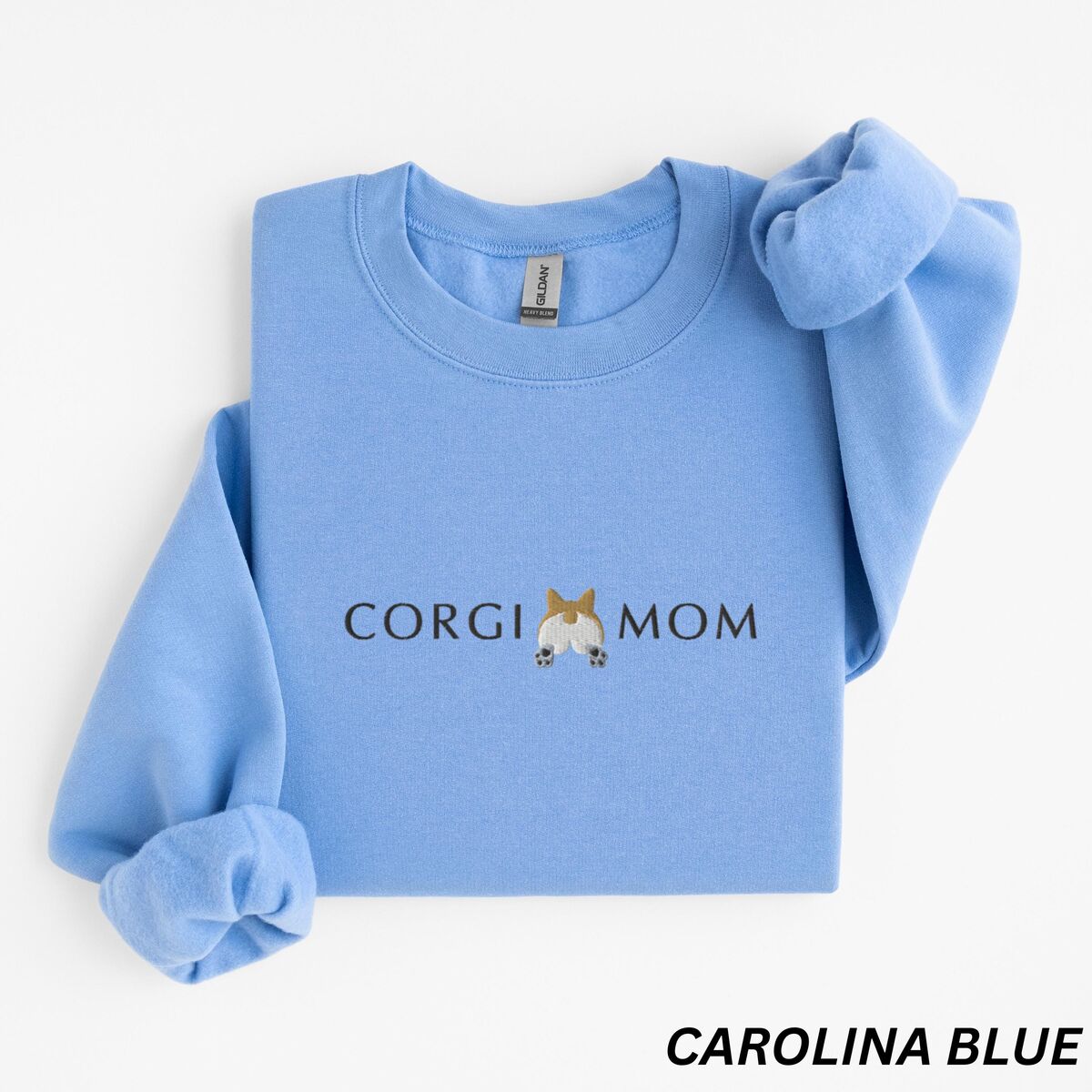 Corgi Butt Sweatshirt - Carolina Blue Carolina Blue crewneck sweatshirt laid flat on white, embroidered with CORGI MOM and a fluffy corgi butt with pointed ears