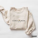 Sand corgi butt sweatshirt laid flat on white, embroidered with CORGI MOM and a fluffy white and tan corgi butt between the words