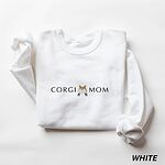 White crewneck sweatshirt laid flat on white, embroidered with CORGI MOM in dark thread and a fluffy corgi butt between the words