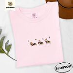 Blossom Comfort Colors T-shirt embroidered with three tricolor corgis in red knit scarves among sprigs of holly