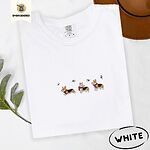 White Comfort Colors T-shirt embroidered with three tricolor corgis in red knit scarves among sprigs of holly