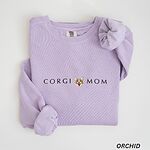 Orchid crewneck sweatshirt laid flat on white, embroidered with CORGI MOM and a small smiling Pembroke corgi face