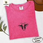 Crunchberry Comfort Colors T-shirt embroidered with a black and white cow head wearing a pink heart bandana tied in a bow