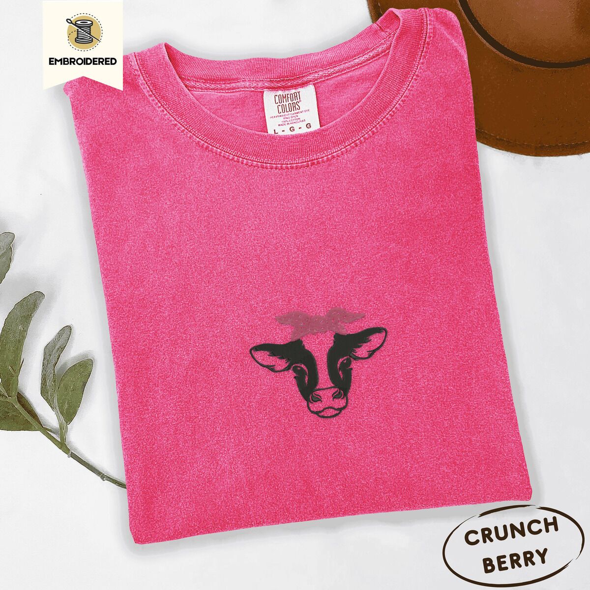 Cow Bandana Shirt – Crunchberry Crunchberry Comfort Colors T-shirt embroidered with a black and white cow head wearing a pink heart bandana tied in a bow