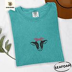 Seafoam Comfort Colors T-shirt embroidered with a black and white cow head wearing a pink heart bandana tied in a bow