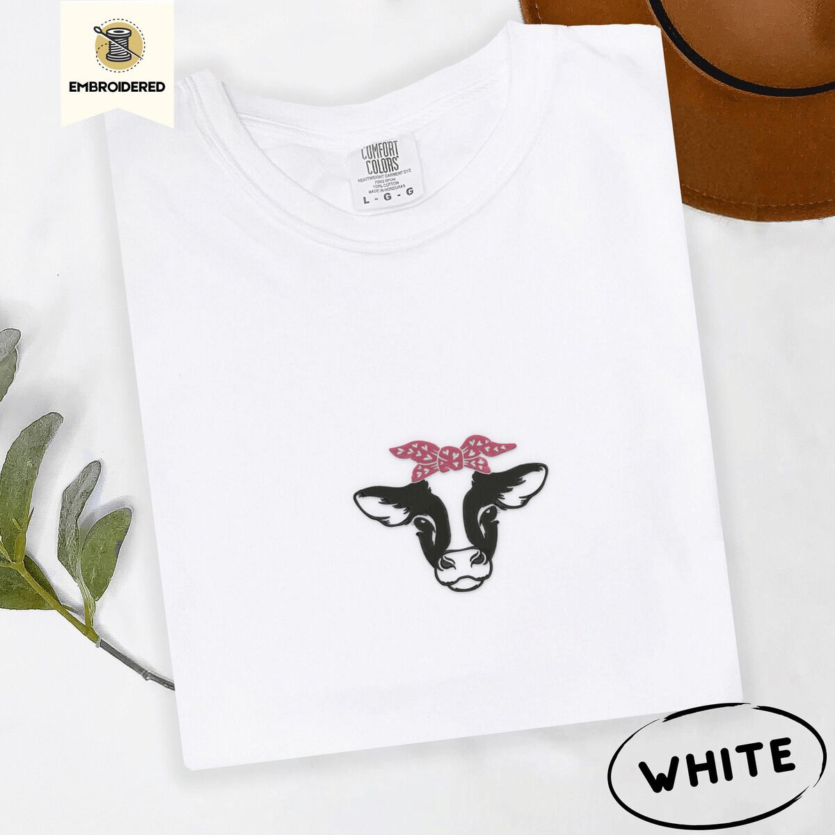 Cow Bandana Shirt – White White Comfort Colors T-shirt embroidered with a black and white cow head wearing a pink heart bandana tied in a bow