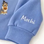 Custom Australian Shepherd sweatshirt with the dog name Mochi embroidered on the sleeve