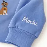 Custom Boxer sweatshirt with the dog name Mochi embroidered on the sleeve