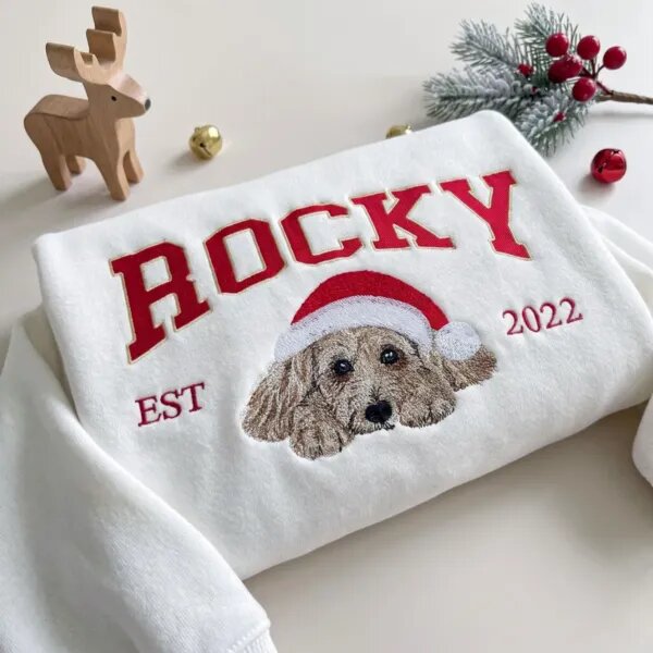 White Christmas sweatshirt with a doodle portrait in a Santa hat under arched varsity name lettering