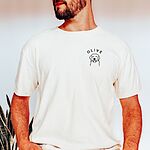 Man in a white T-shirt embroidered with a line art golden retriever face and the name OLIVE on the left chest