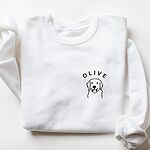 White crewneck sweatshirt laid flat, embroidered with a line art golden retriever face and the name OLIVE on the left chest