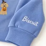 Custom Miniature Poodle sweatshirt with the dog name Biscuit embroidered on the sleeve