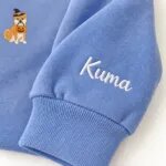 Custom Shiba Inu sweatshirt with the dog name Kuma embroidered on the sleeve