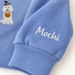 Custom Standard Poodle sweatshirt with the dog name Mochi embroidered on the sleeve