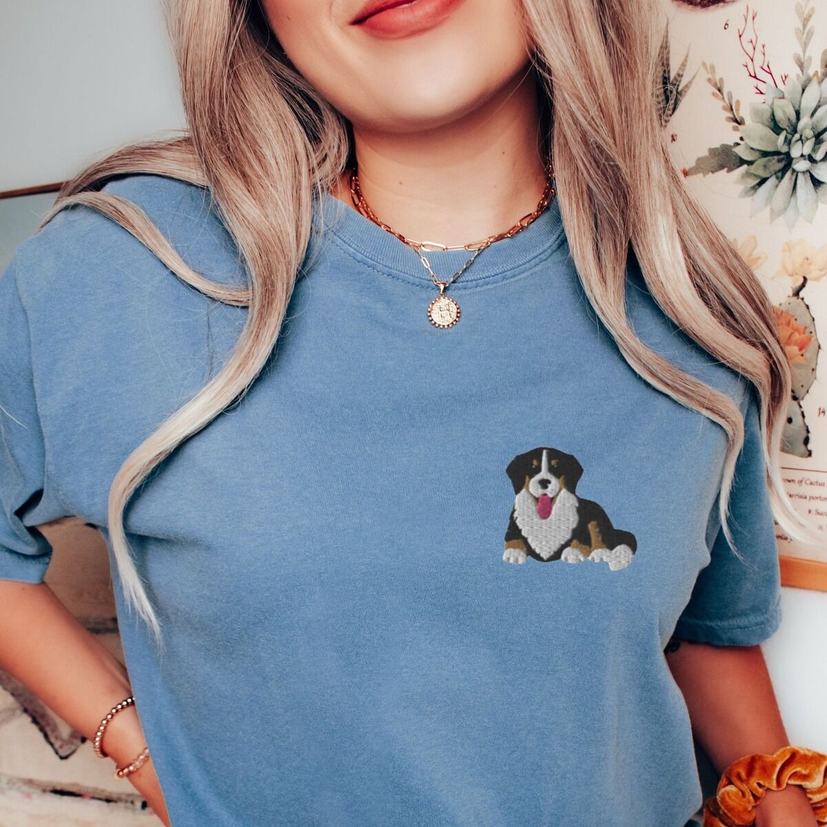 Cute Bernese Mountain Dog Shirt – Blue Jean Woman in a Blue Jean T-shirt embroidered with a small tricolor Berner puppy lying down on the left chest