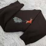 Dachshund Christmas sweatshirt in Dark Chocolate with a wiener dog in antlers pulling a Christmas tree on a sled