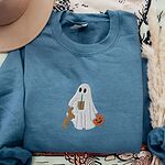 Indigo Blue crewneck sweatshirt with a brown hat and pampas grass, embroidered with a ghost sipping iced coffee and a red dachshund standing up at her side, the red coat option