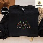Black crewneck sweatshirt with a brown felt hat and dried bunny tail grass, embroidered with four black and tan dachshunds in Santa hats leaping between mistletoe sprigs with red bows and silver snowflakes