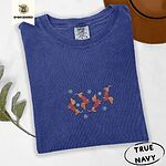True Navy Comfort Colors T-shirt embroidered with four red dachshunds in red Fair Isle sweaters tumbling among light blue snowflakes