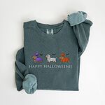 Blue Spruce crewneck sweatshirt laid flat on white, embroidered with three dachshunds dressed as a witch, a mummy and a pumpkin with bats overhead, above the words HAPPY HALLOWEENIE