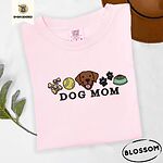 Blossom Comfort Colors T-shirt embroidered with a row of dog treats, a tennis ball, a chocolate Lab face, paw prints and a food bowl above the words DOG MOM