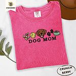 Crunchberry Comfort Colors T-shirt embroidered with a row of dog treats, a tennis ball, a chocolate Lab face, paw prints and a food bowl above the words DOG MOM