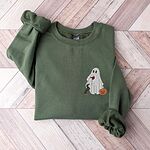 Military Green crewneck sweatshirt laid flat on a wood floor, embroidered on the left chest with a ghost sipping red wine, a black and tan dachshund and a jack-o'-lantern