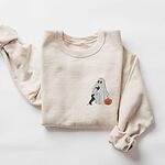 Sand crewneck sweatshirt laid flat on white, embroidered on the left chest with a ghost sipping red wine, a black and tan dachshund and a jack-o'-lantern