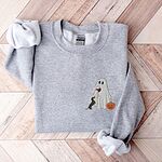 Sport Grey crewneck sweatshirt laid flat on a wood floor, embroidered on the left chest with a ghost sipping red wine, a black and tan dachshund and a jack-o'-lantern