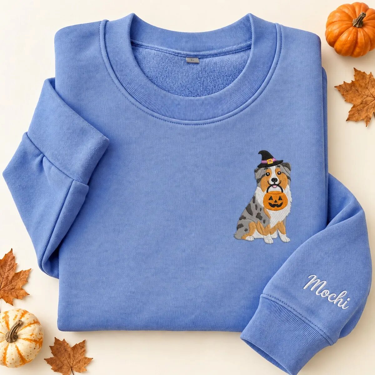 Embroidered Australian Shepherd Halloween Sweatshirt – Heather Deep Royal Embroidered Australian Shepherd Halloween sweatshirt in Heather Deep Royal with a witch-hat Australian Shepherd holding a pumpkin bucket on the left chest