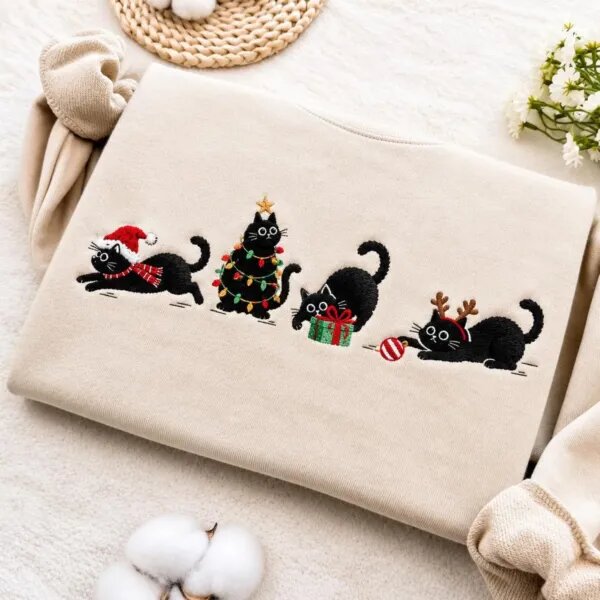 Black cat Christmas sweatshirt in Sand with four embroidered black cats in a Santa hat, Christmas lights, a gift box and reindeer antlers