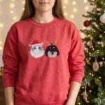 Red Christmas sweatshirt with an embroidered cat in a Santa hat and a black doodle in reindeer antlers