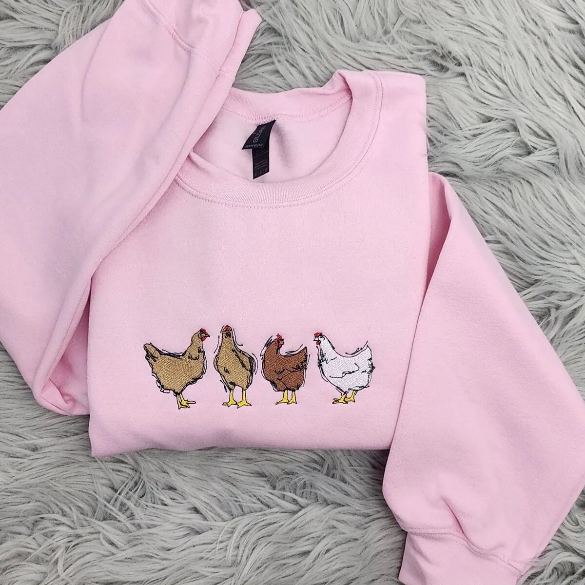 Embroidered Chicken Sweatshirt – Light Pink Embroidered chicken sweatshirt in Light Pink with four farm hens in buff, red and white across the chest