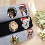 Three embroidered Christmas dog sweatshirts in grey and black with dog portraits in Santa hats next to the original photos