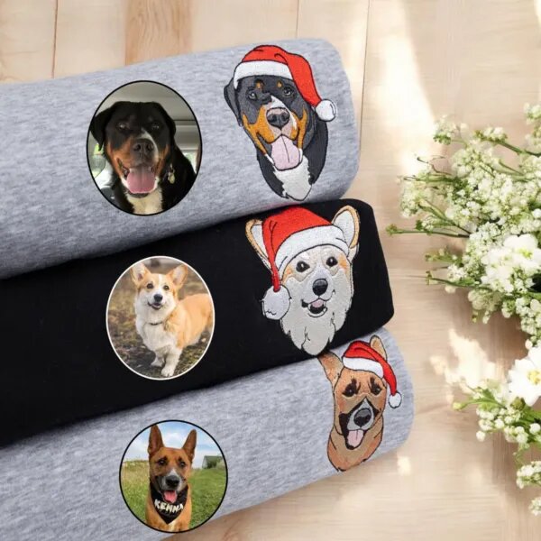 Three embroidered Christmas dog sweatshirts in grey and black with dog portraits in Santa hats next to the original photos