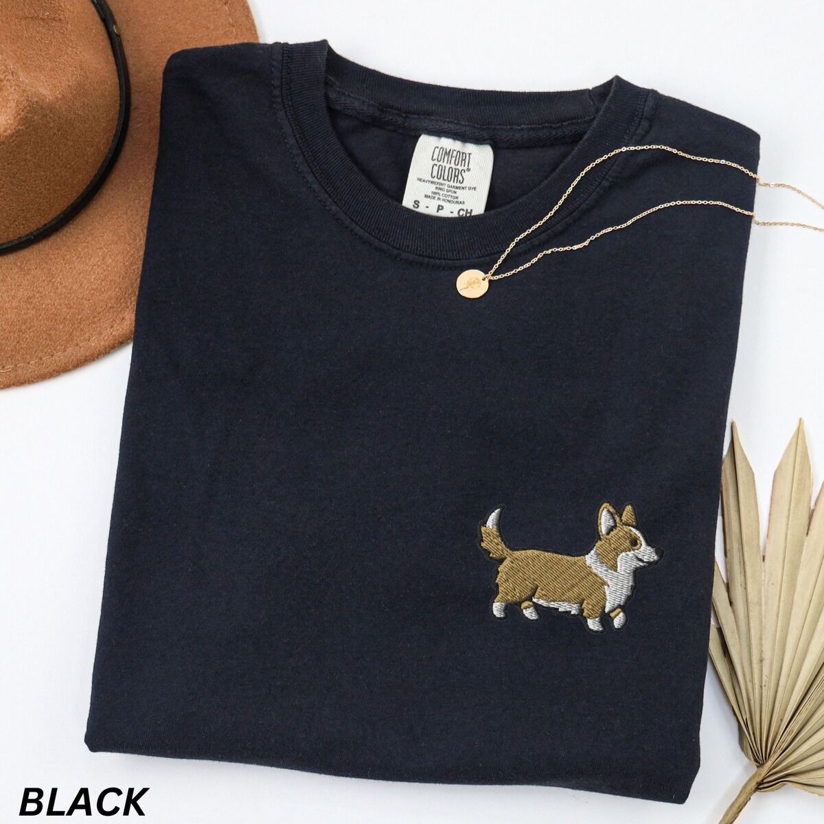 Embroidered Corgi Shirt – Black Black Comfort Colors T-shirt embroidered with a cute cartoon corgi in golden tan and white trotting on the left chest