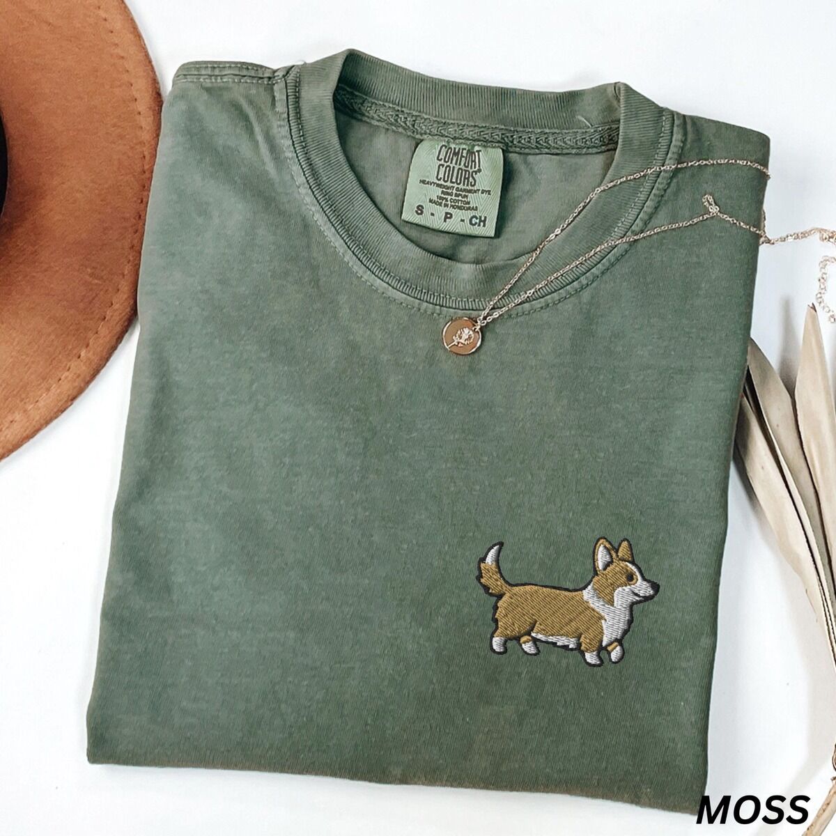 Embroidered Corgi Shirt – Moss Moss Comfort Colors T-shirt embroidered with a cute cartoon corgi in golden tan and white trotting on the left chest