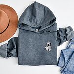 Dark Heather Gildan 18500 hoodie embroidered with a little white ghost hugging a black cat on the left chest