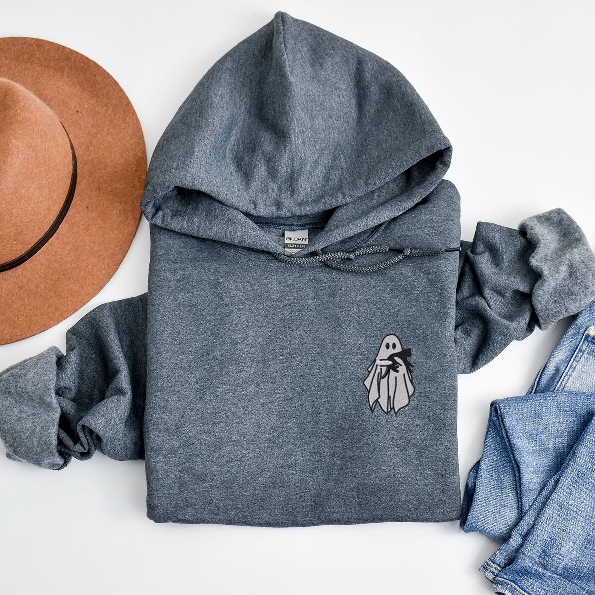 Embroidered Ghost Hoodie – Dark Heather Dark Heather Gildan 18500 hoodie embroidered with a little white ghost hugging a black cat on the left chest