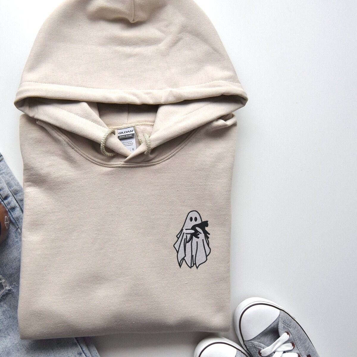 Embroidered Ghost Hoodie – Sand Sand Gildan 18500 hoodie embroidered with a little white ghost hugging a black cat on the left chest