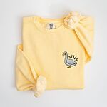 Butter yellow crewneck sweatshirt laid flat with a knotted sleeve, embroidered with a little white goose with the word silly arched over its back on the left chest