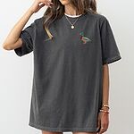 Woman in an oversized Pepper T-shirt embroidered with a small drake mallard on the left chest