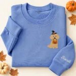 Embroidered Miniature Poodle Halloween sweatshirt in Heather Deep Royal with a witch-hat Miniature Poodle holding a pumpkin bucket on the left chest