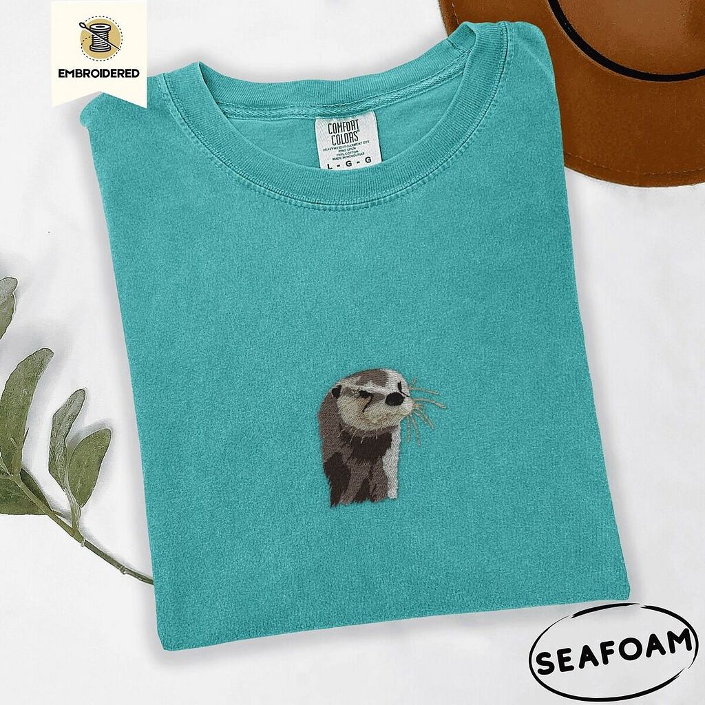 Comfort Colors 1717 T-shirt in Seafoam with an embroidered river otter head