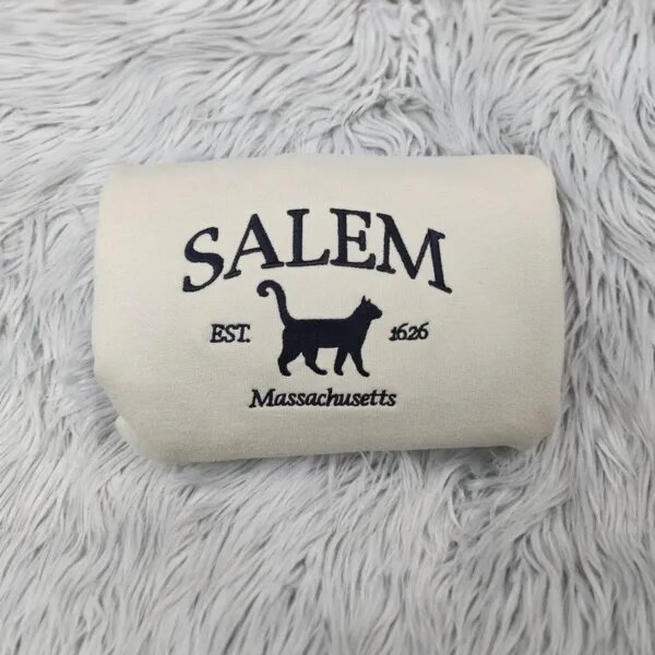 Embroidered Salem sweatshirt in Sand with SALEM, a black cat silhouette, Est. 1626 and Massachusetts stitched in black thread