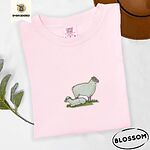 Blossom Comfort Colors T-shirt embroidered with a woolly white ewe standing over her lamb resting on green grass