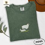 Moss Comfort Colors T-shirt embroidered with a woolly white ewe standing over her lamb resting on green grass
