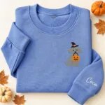 Embroidered Toy Poodle Halloween sweatshirt in Heather Deep Royal with a witch-hat Toy Poodle holding a pumpkin bucket on the left chest